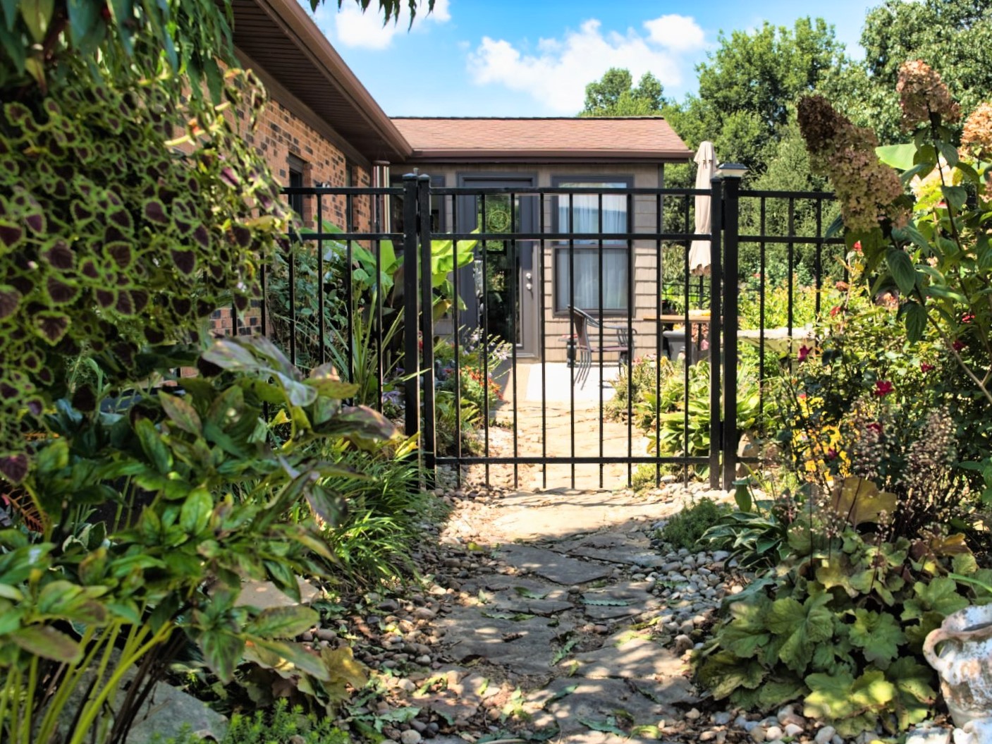 Photo of an aluminum fence and gate at a home entryway