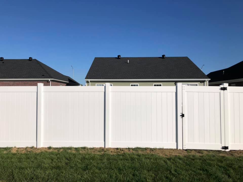 Photo of a white vinyl privacy fence